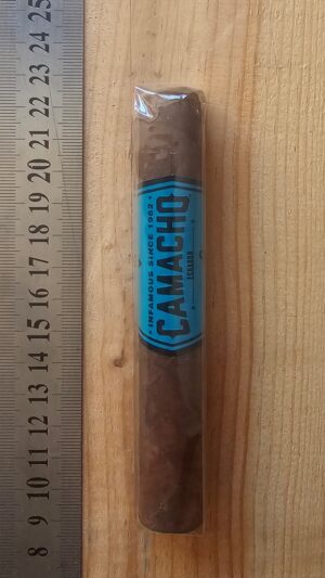 Camacho Ecuador Robusto Cigar next to ruler for scale