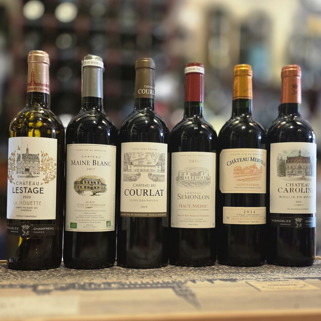 Bordeaux Wine Month 2026 mixed case featuring six bottles of French red and white wine from Fareham Wine Cellar,Chateau Lestage La Mouette Bordeaux Blanc 2020 white wine bottle,Chateau Maine Blanc 2017 Blaye Cotes de Bordeaux red wine bottle,Chateau Du Courlat Cuvee Jean-Baptiste Lussac Saint-Emilion 2015 red wine bottle,Chateau Semonlon Haut-Medoc AC 2021 red wine bottle,Chateau Merville 2014 Saint-Estephe red wine bottle